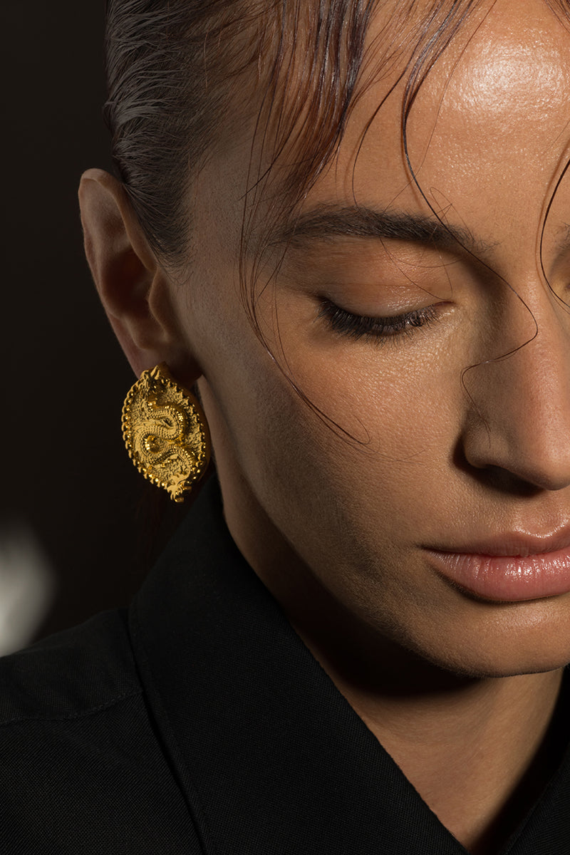 Natia x Lako dragon earrings featuring detailed dragon-shaped design in silver metal, hanging from French hooks.