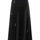 Black rose embroidered midi skirt by DELEGAN, featuring intricate floral embroidery and a flowing midi length.