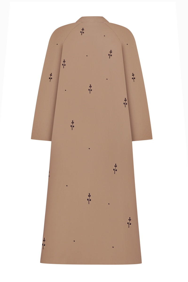 Beige rose embroidered trench coat by DELEGAN, shown with detailed embroidery and classic trench design, stylish and elegant outerwear.