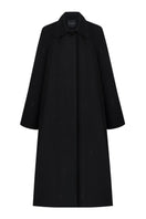 Black trench coat by Delegan hanging on a wooden hanger, showcasing classic design and tailored fit.