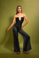 Black TATACOA pants by LAURA ESCOBAR, featuring a sleek fit and fabric details, displayed on a model.