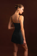 Black Laura Escobar Sun mini dress with sleeveless design and fitted silhouette, perfect for summer occasions.