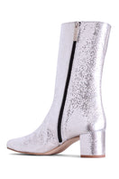 Silver Olivia boots by Terry de Havilland, stylish ankle boots with metallic finish and pointed toes, shown on model.