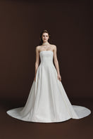 BalYKINA Gabby matte silk gown displayed on a mannequin, featuring a sleek, elegant design with a high neckline and flowing fabric.