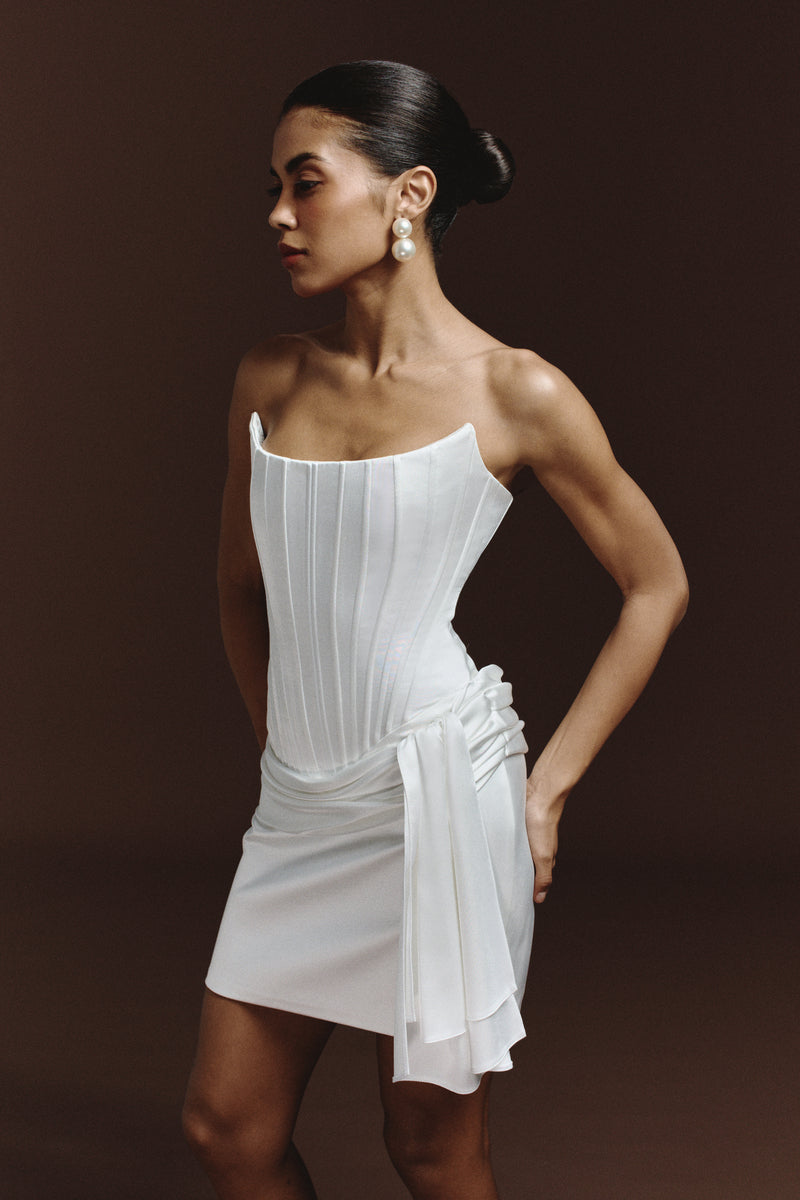 BalYKINA Irma mini dress with floral pattern, sleeveless design, and fitted silhouette, showcased on a model.