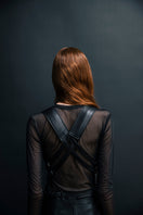Black leather vest with belt from Vaska, showcasing a stylish jacket with detailed belt and sleek leather texture.