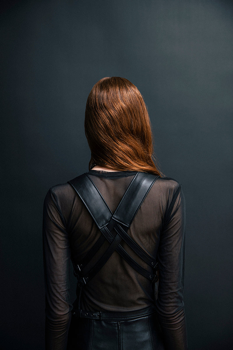 Black leather vest with belt from Vaska, showcasing a stylish jacket with detailed belt and sleek leather texture.