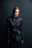 Black textured leather jacket by Vaska featuring a stylish, fitted design and classic collar detail.