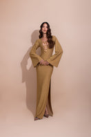 Gold long maxi dress by LAURA ESCOBAR featuring elegant fabric and flowing design, perfect for formal occasions.