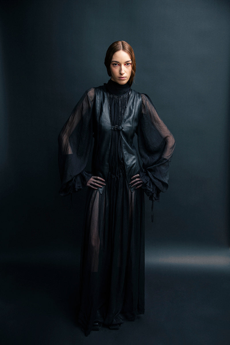 Black leather vest with belt from Vaska, featuring a stylish jacket design and adjustable waist strap.