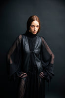 Black leather vest with belt from Vaska, stylish jacket featuring a sleek design and adjustable waist strap.