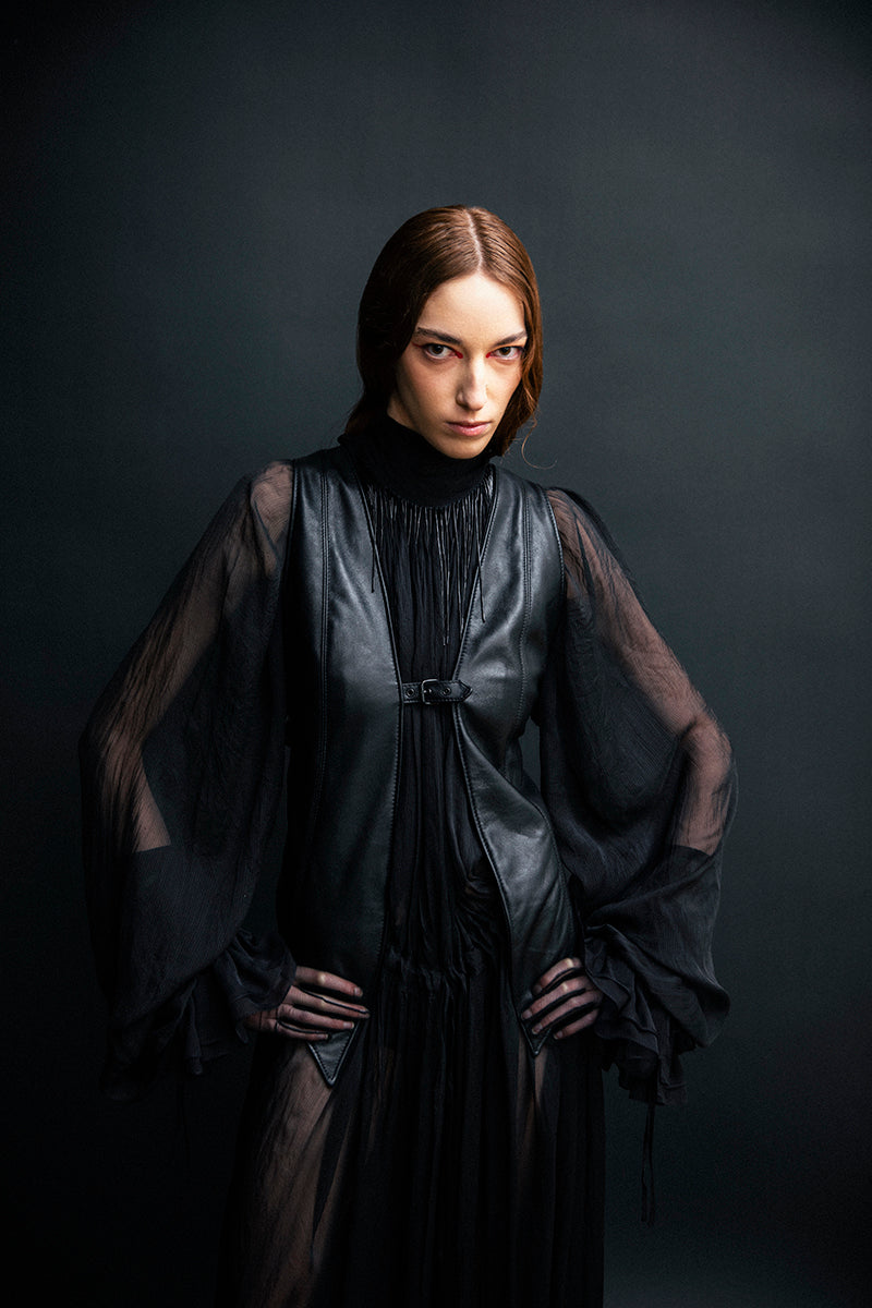 Black leather vest with belt from Vaska, stylish jacket featuring a sleek design and adjustable waist strap.