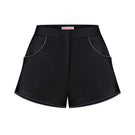 Black Sayya mini shorts displayed on a hanger, showcasing their fitted design and simple style.