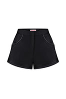 Black Sayya mini shorts displayed on a hanger, showcasing their fitted design and simple style.