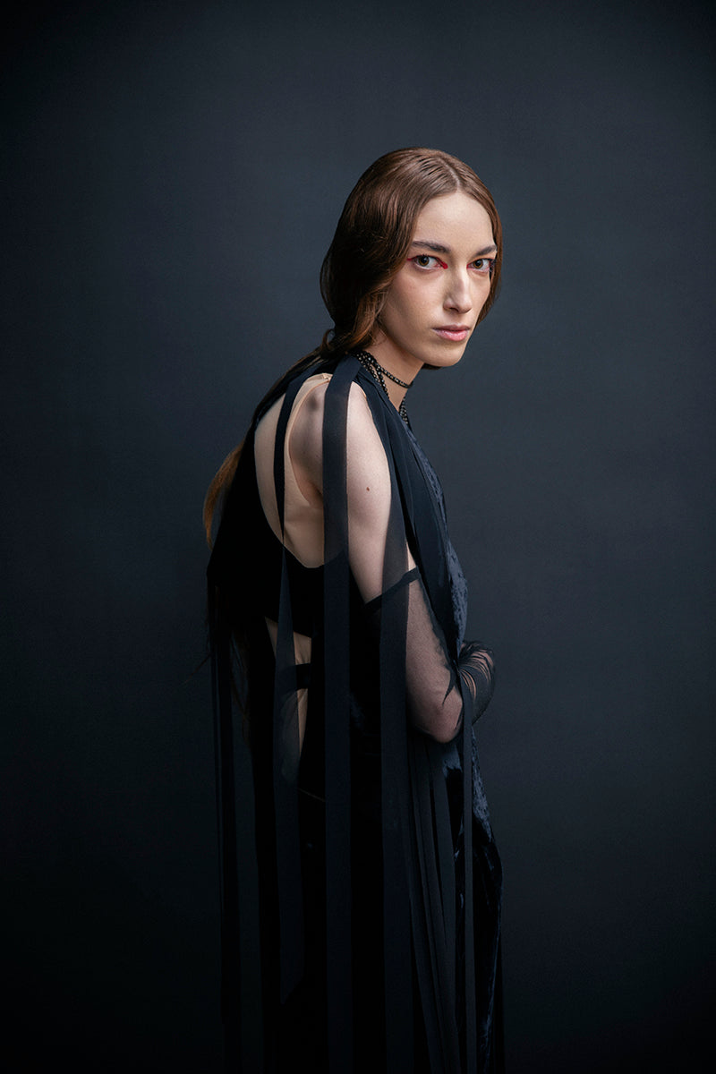 Black Vaska jacket with chiffon ribbons, stylish outerwear featuring elegant fabric and a modern design.