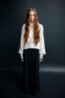 Beige Vaska feather-detail blouse with long sleeves and elegant design, perfect for stylish casual or dressy occasions.