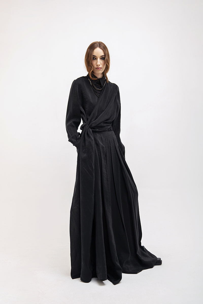 Black wide-leg pants by Vaska, showing the flowy fabric and relaxed fit, perfect for casual or stylish outfits.