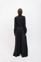 Black wide leg pants by Vaska featuring a relaxed fit and stylish silhouette, shown on a model.