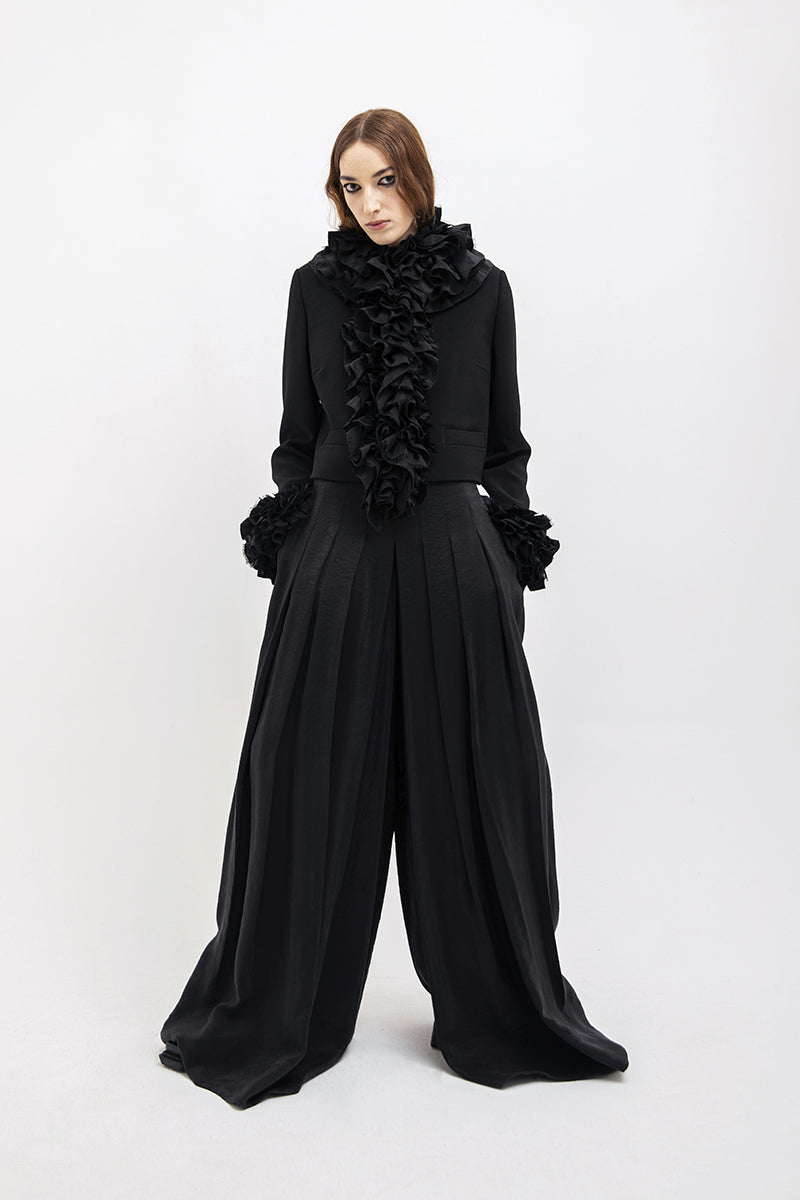 Black Vaska crop jacket with ruffles, stylish women's jacket featuring a trendy ruffled design and fitted silhouette.
