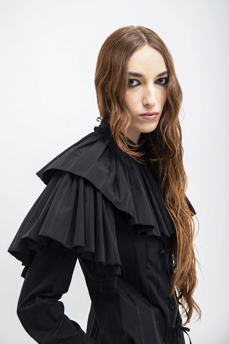 Black Vaska shirt with a large collar, featuring a stylish and modern design, displayed on a plain background.