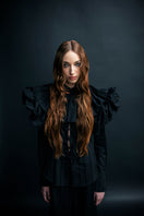 Black Vaska shirt featuring a prominent oversized collar, shown laid flat with long sleeves and button-front design.