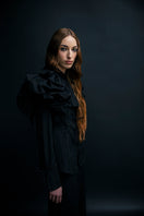 Black Vaska shirt with a large collar, featuring a stylish and modern design, shown on a mannequin.