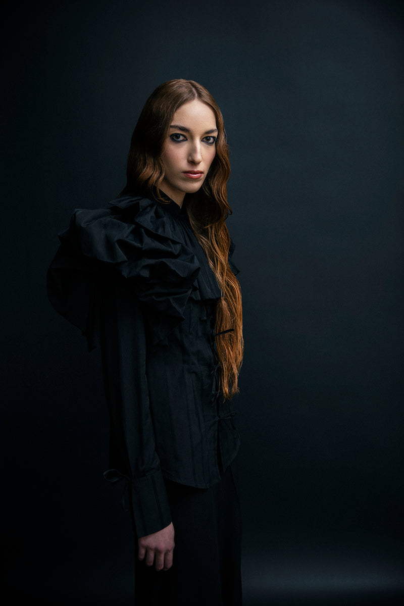 Black Vaska shirt with a large collar, featuring a stylish and modern design, shown on a mannequin.
