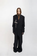 Black oversized blazer by Vaska featuring intricate beaded embroidery, stylish and suitable for contemporary fashion.