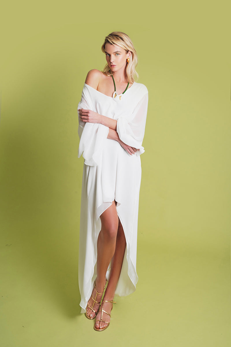 White PAZ maxi dress by Laura Escobar, flowing fabric with elegant design, perfect for summer or special occasions.