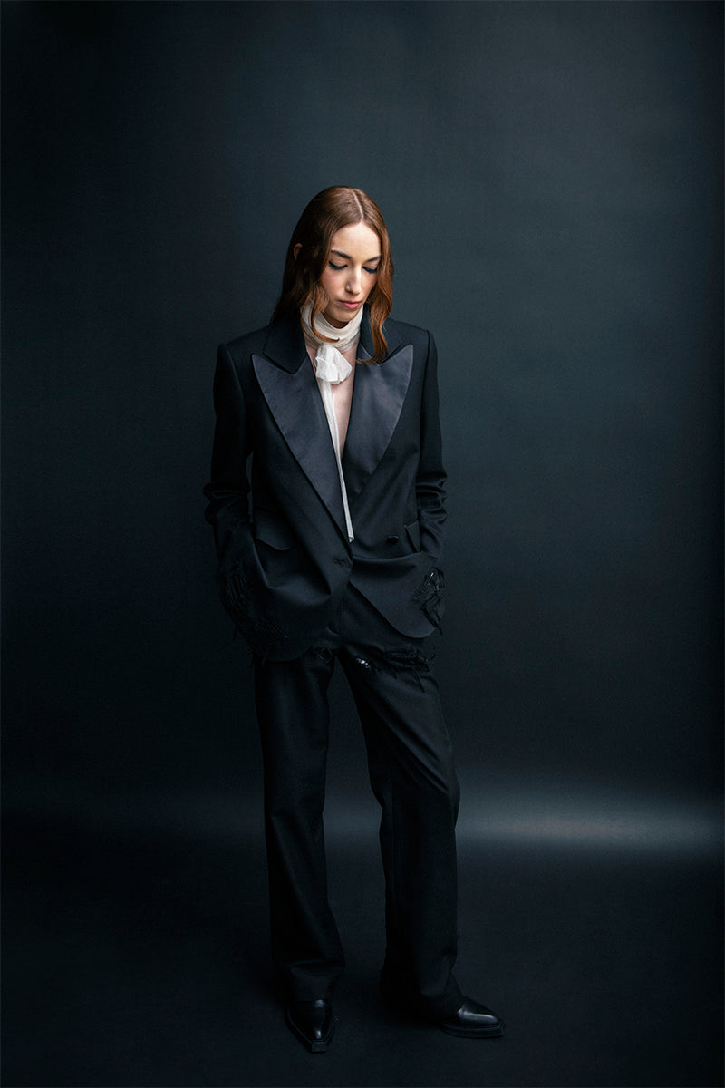 Black distressed Vaska jacket with a rugged, worn-in look, featuring frayed edges and a casual style.