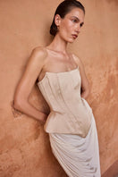 Beige EVA corset top by BALYKINA featuring a fitted design and adjustable straps, styled for a modern, chic look.