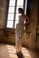 BALYKINA MUNA gown, elegant formal dress with flowing fabric and intricate detailing, showcased in a stylish fashion setting.