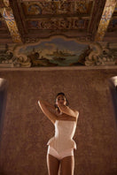 Beige EVA corset top by BALYKINA with structured design and adjustable straps, displayed on a neutral background.