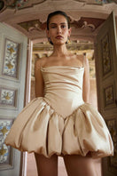 Beige Saris mini dress by Balykina displayed on a hanger with detailed fabric texture and elegant design.