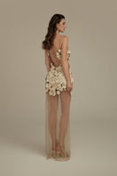 Cream white Seraphina maxi dress by POEM, flowing fabric with elegant design, displayed on a hanger.