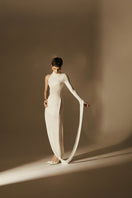 White HYPERION maxi dress by POEM, flowing fabric and elegant design, perfect for summer or special occasions.