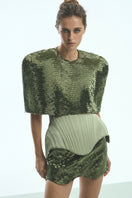 Light-green Irma corset top by Balykina, featuring structured design and decorative details, shown on a model.
