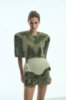 Light-green Irma corset top by Balykina, featuring a fitted design and intricate detailing, displayed on a mannequin.