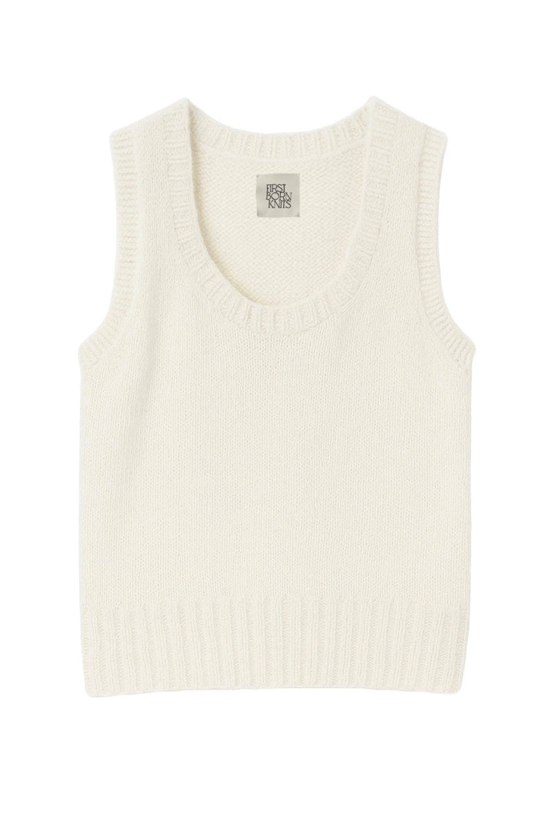 White Chloe vest from First Born Knits, a stylish knit top with a fitted design and textured fabric.