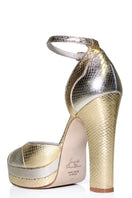 Gold Lily platform block heel shoes by Terry de Havilland, featuring a stylish heel design and a sleek gold finish.