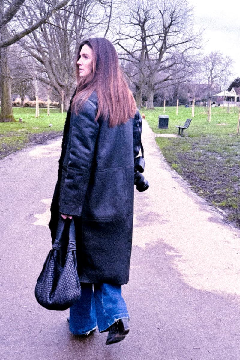 Black Verheyen Zina biker shearling coat with lapel collar and zipper details, worn as a stylish outerwear piece.