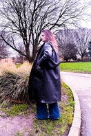 Black Verheyen Zina biker shearling coat with wide lapels and silver hardware, shown on a model.