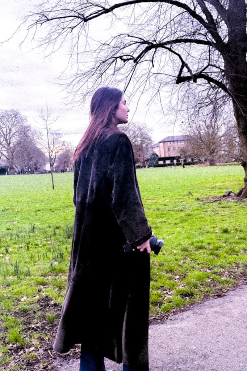 Black Verheyen Zina Biker Shearling coat with lapel collar and zipper details, displayed on a hanger.