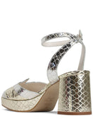 Terry de Havilland Sima block heels showing beige textured leather with chunky heel and ankle strap on a neutral background.