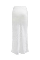 Nué Veronique white midi skirt with a flowy, elegant design, showcased on a model in a stylish fashion setting.