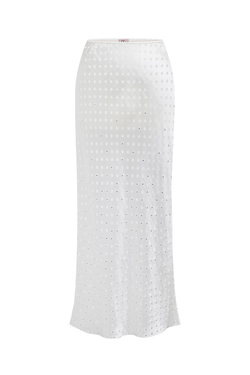 White Nué Veronique midi skirt, flowing fabric with a stylish design, displayed on a hanger against a neutral background.