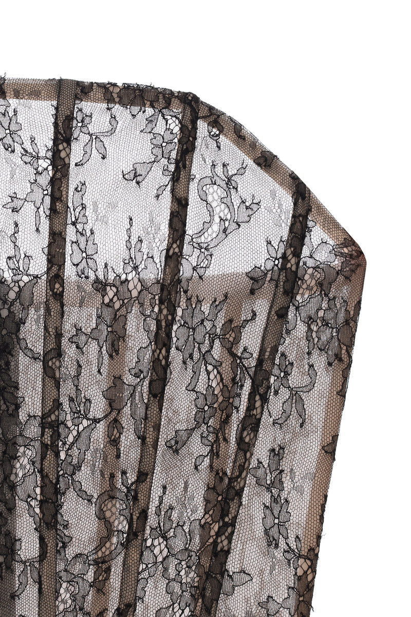 Nué Allure Corset Top displayed on a hanger, showcasing its fitted design and stylish details in a close-up image.