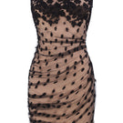 Nué Bettina dress, a stylish mini dress with a fitted silhouette and elegant design, shown on a model.