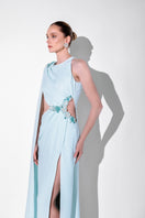 Blue embellished cape gown by Monika Dimova, featuring intricate beadwork and flowing fabric, perfect for elegant occasions.