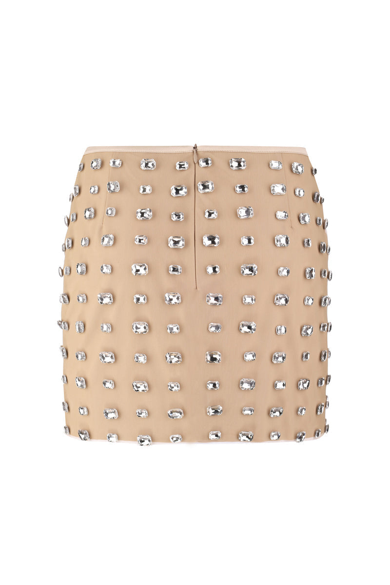 Nué Chantal mini skirt, stylish short skirt with a fitted design, shown in a flattering pose on a model.